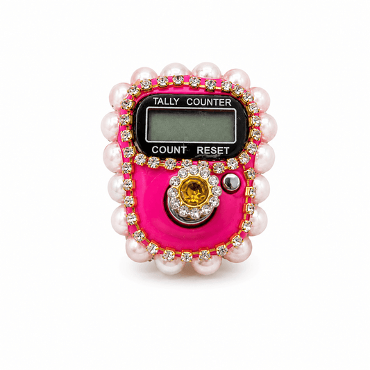 Pink tally counter with pearls and gemstones on a white background