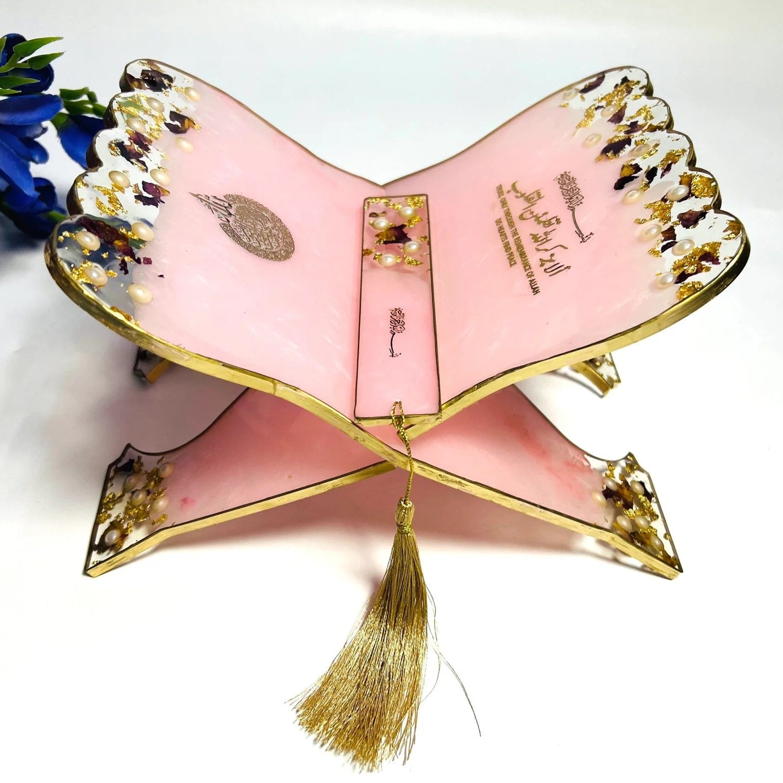Islamic book holder rehal made of resin with delicate floral design and bookmark.