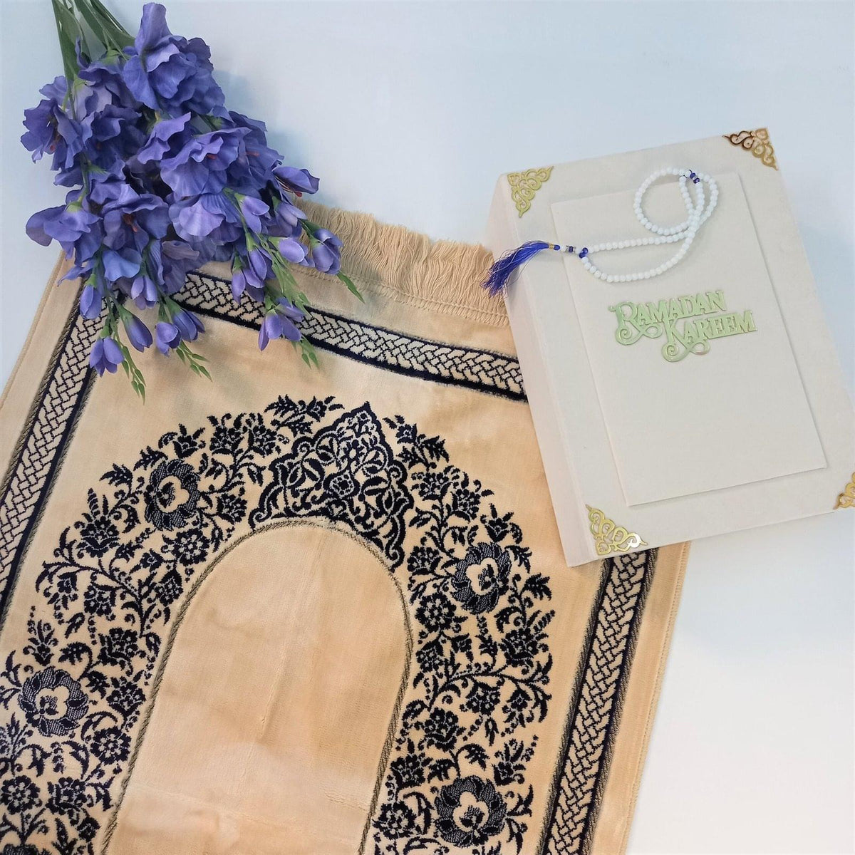 Soft velvet prayer mat in gold and royal blue, perfect for Ramadan or gifting.