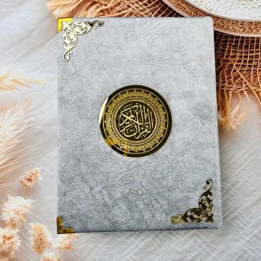Premium hardcover Quran Al-Karim in soft grey velvet finish.