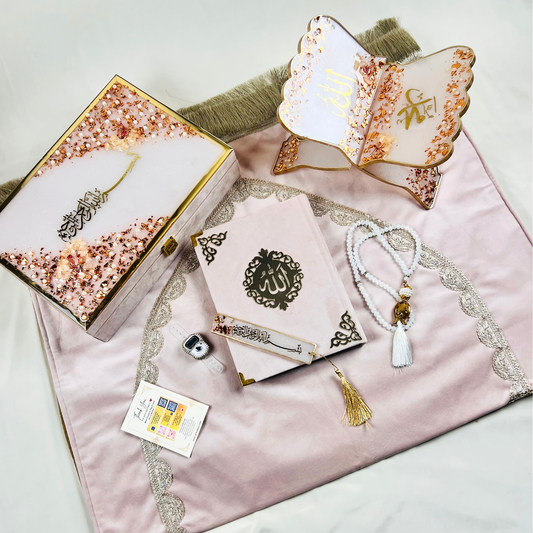 Misty Rose Barkat-e-Jariyah resin Quran hamper, luxury Islamic prayer essentials gift set including velvet Quran, handmade prayer mat, resin rehal, tasbih, bookmark, and personalized velvet box.