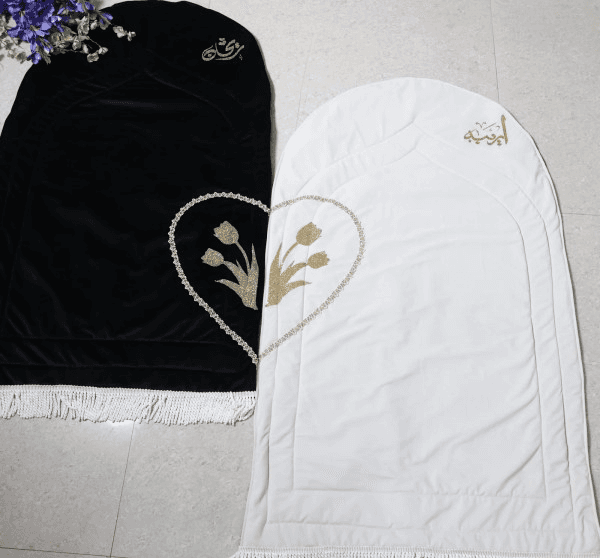 Personalised velvet couple prayer rug set in black and white rose design, luxury handmade Islamic wedding gift and Nikah prayer mat for Muslim couples.