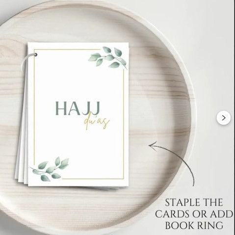 Physical dua cards for Hajj including Arabic, English, and transliteration text.