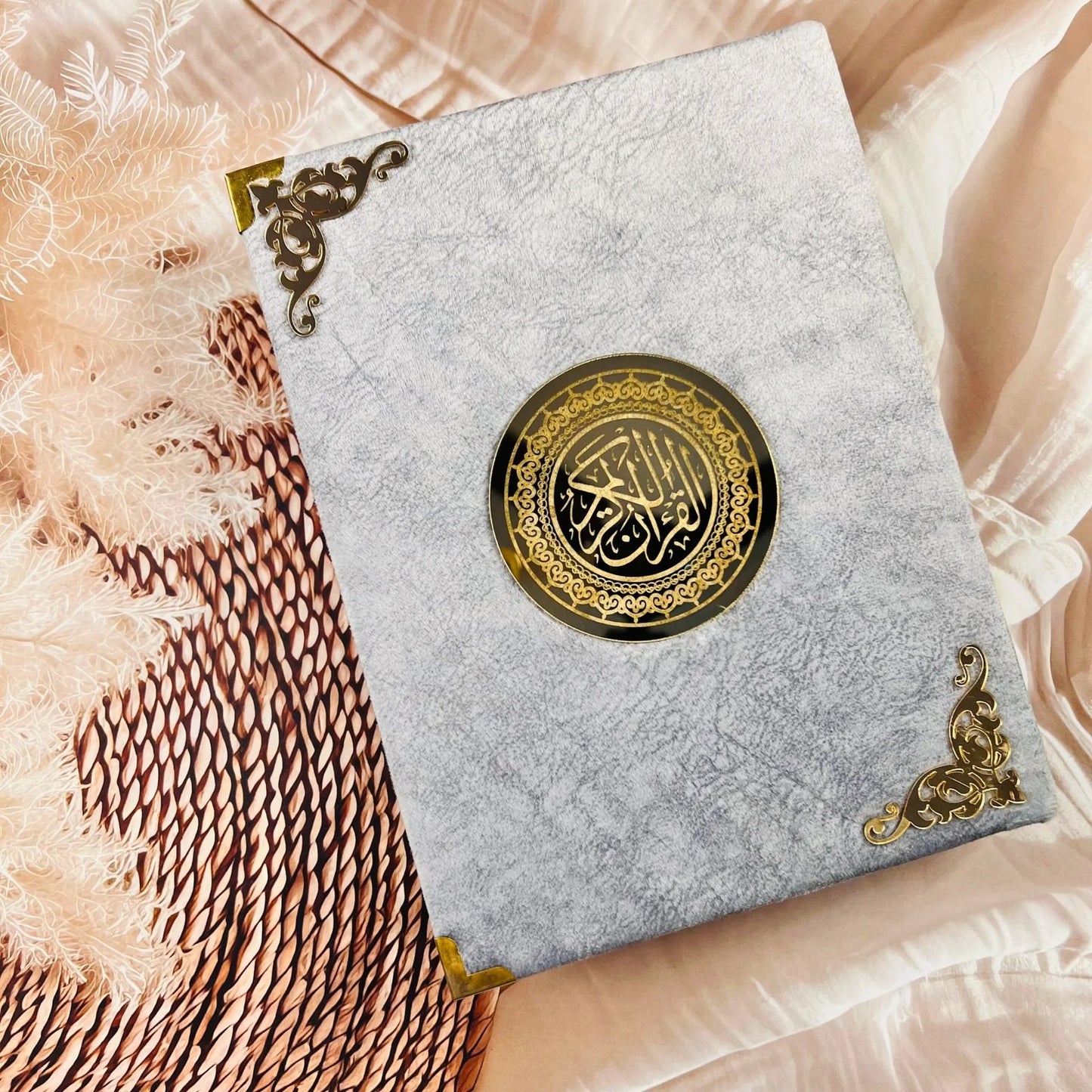 Grey velvet Holy Quran with Roman Urdu transliteration and English translation.