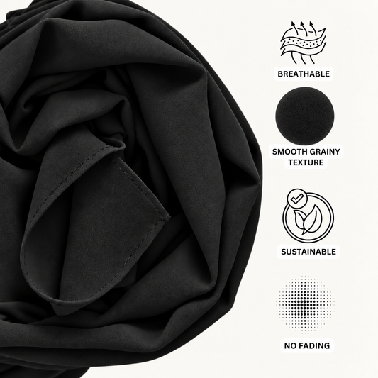 Black fabric shown in a close-up with printed feature icons and text on the right reading 'BREATHABLE', 'SMOOTH GRAINY TEXTURE', 'SUSTAINABLE', and 'NO FADING'.