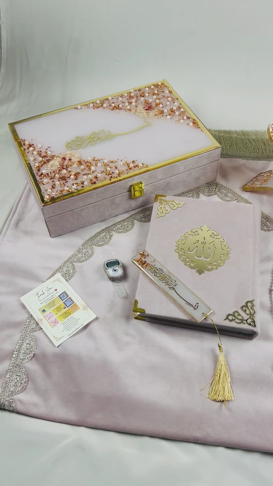 Misty Rose Barkat-e-Jariyah resin Quran hamper, luxury Islamic prayer essentials gift set including velvet Quran, handmade prayer mat, resin rehal, tasbih, bookmark, and personalized velvet box.
