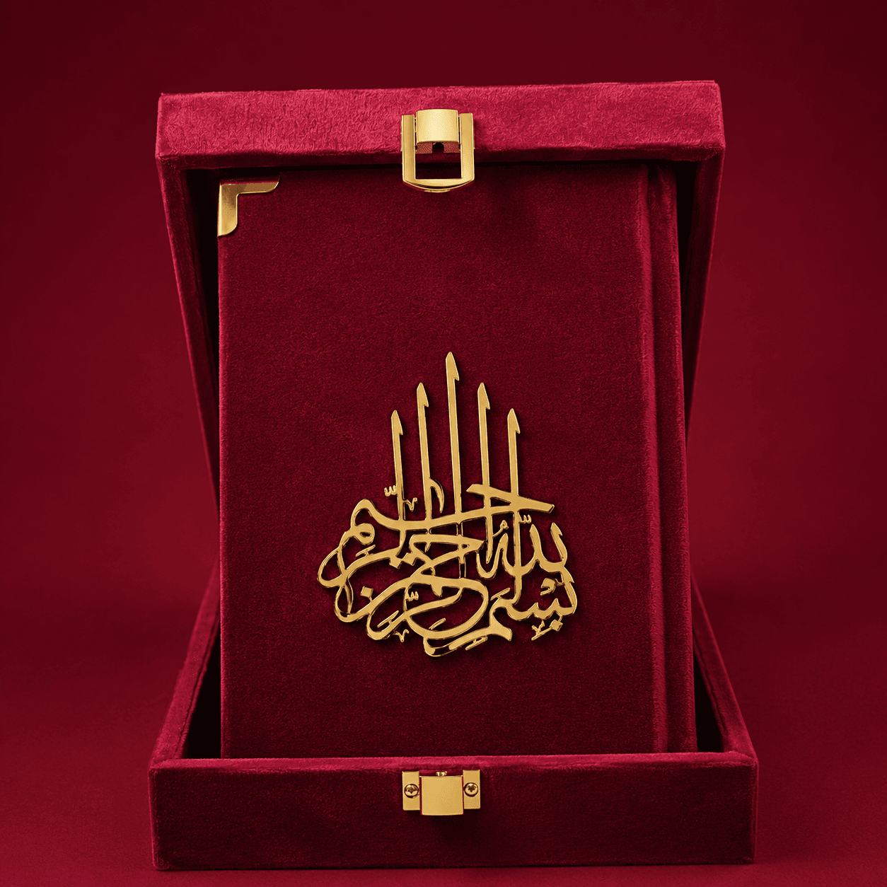A gold metal Islamic calligraphy plaque of Ayat al-Kursi, displayed inside an open deep red velvet presentation box with gold-tone hardware.