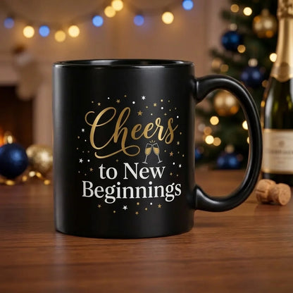 Black Ceramic New Year Mug with Gold Cheers Calligraphy Script, Clinking Champagne Glasses, and White to New Beginnings Text
