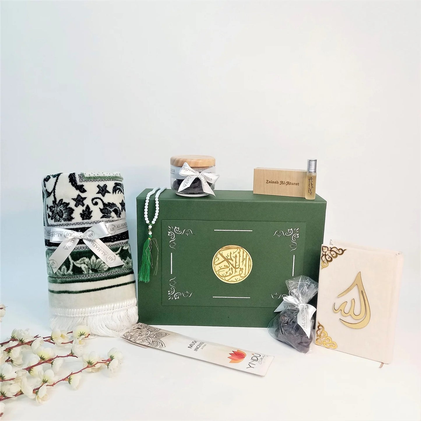 Elegant Ramadan or Eid gift set with olive green Quran, tasbih, and Oud perfume