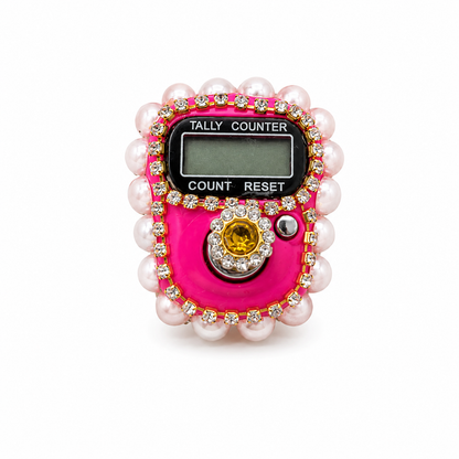 Pink tally counter with pearls and gemstones on a white background