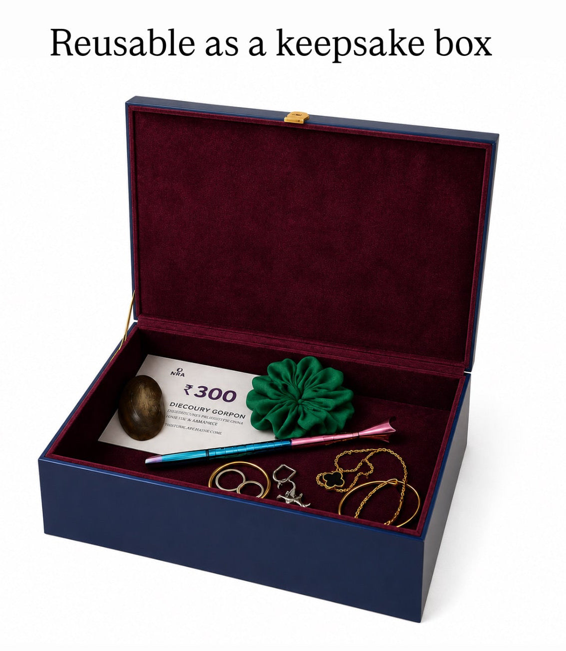 A dark blue keepsake box with a deep burgundy velvet interior, shown open on a white background. The box contains sample jewelry and a card labeled '¥300', with text above reading 'Reusable as a keepsake box'.