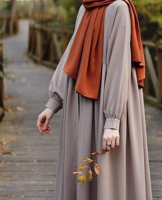 Premium Nida abaya in loose fit design featuring cuffed sleeves and elegant fall.