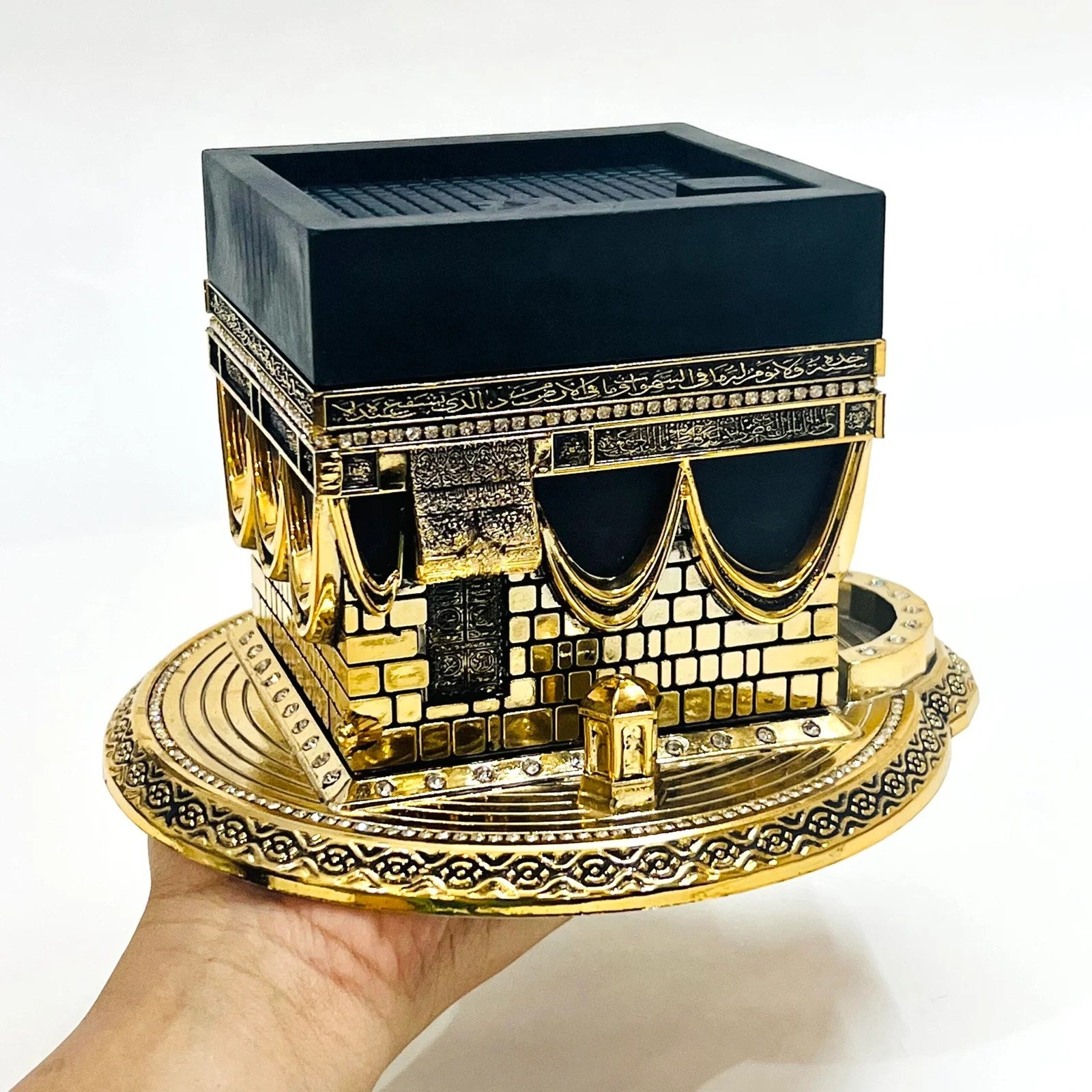 Golden Kaaba replica with Arabic calligraphy and luxury detailing.