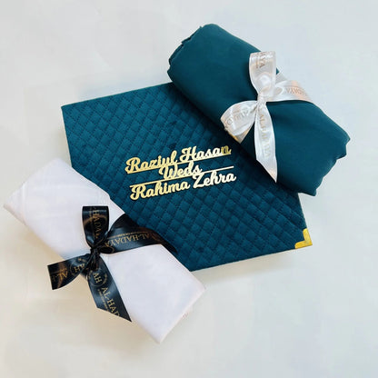 Emerald green Islamic couple gift box with tasbih, perfume, hijab, and men’s scarf.