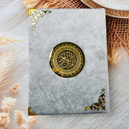 Premium hardcover Quran Al-Karim in soft grey velvet finish.