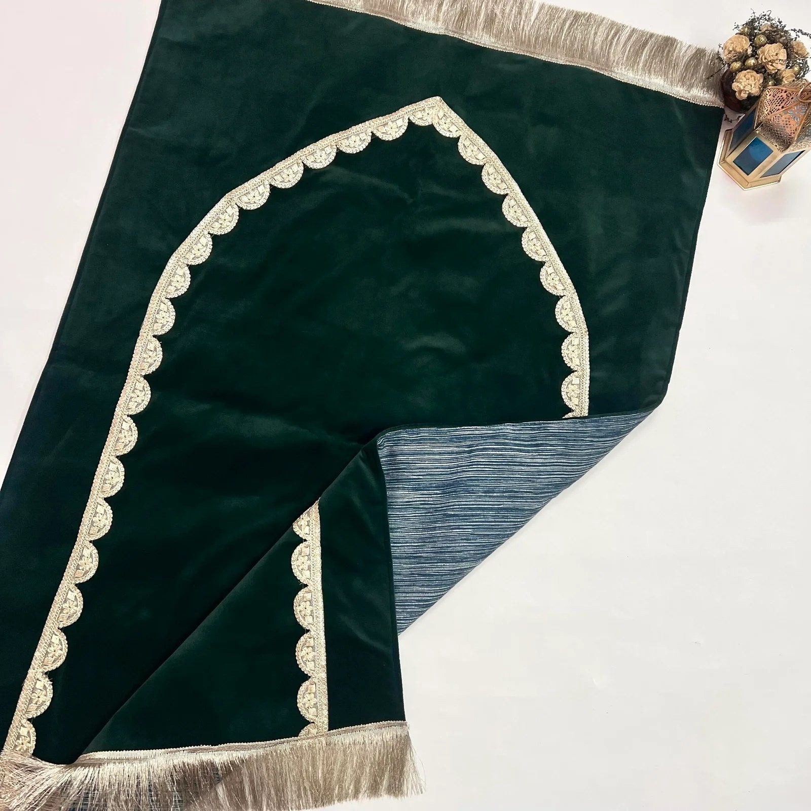 Premium handmade velvet janamaz in olive green with gold detailing.