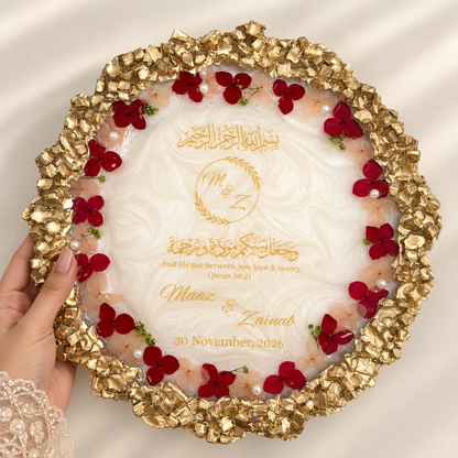 Premium personalized Nikah resin plaque featuring a pearlescent white center, intricate gold textured border, red and blush dried flowers, pearls, Arabic calligraphy, couple’s names and wedding date.