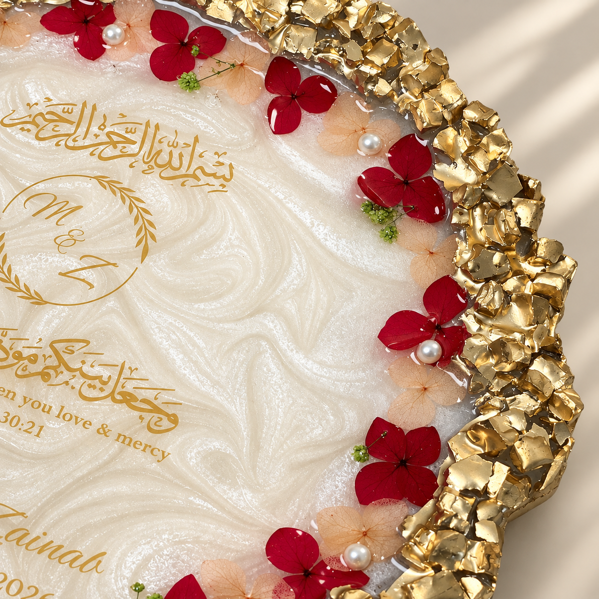 Premium personalized Nikah resin plaque featuring a pearlescent white center, intricate gold textured border, red and blush dried flowers, pearls, Arabic calligraphy, couple’s names and wedding date.