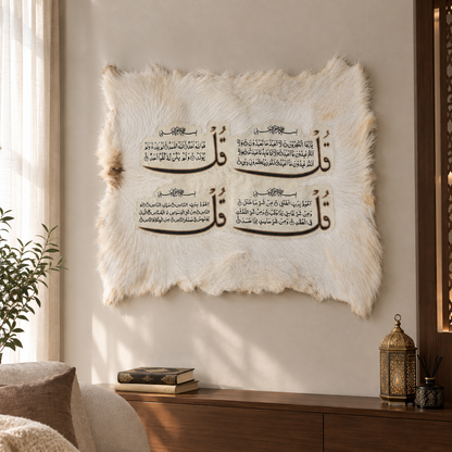 A square white faux-fur wall hanging with black Arabic calligraphy displayed on a beige wall in a styled interior setting with a console table, lantern, and plant.
