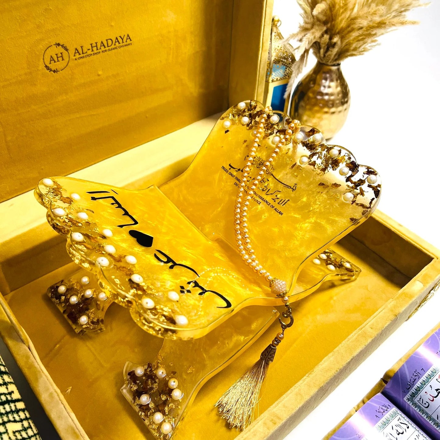 Luxurious Islamic prayer essentials set in golden velvet with Quran, resin accessories, and Turkish mat.