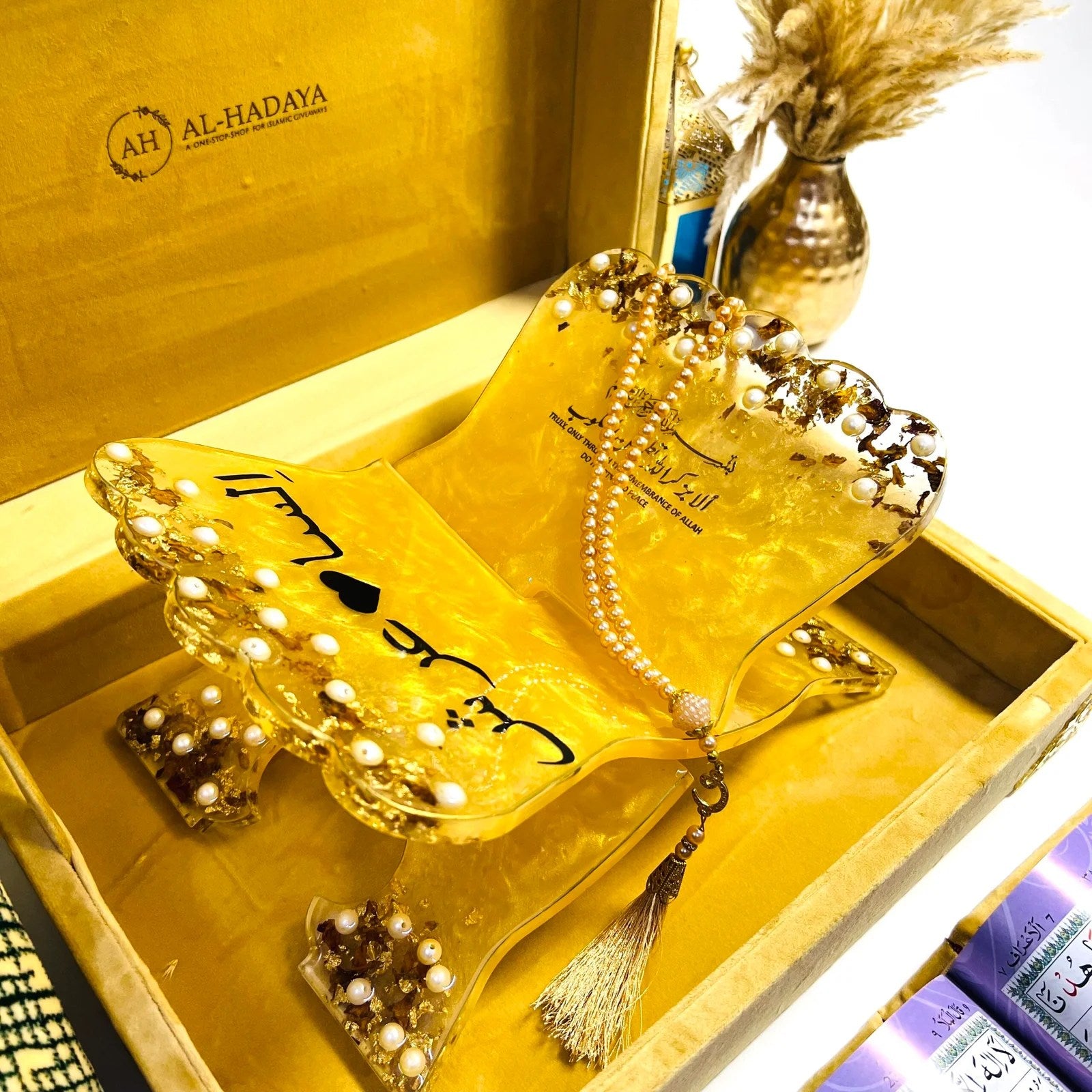 Luxurious Islamic prayer essentials set in golden velvet with Quran, resin accessories, and Turkish mat.