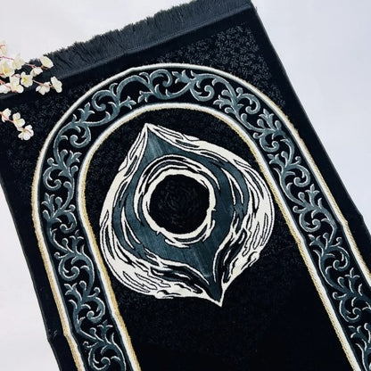 Soft chenille adult prayer mat with intricate Hajr-e-Aswad design.