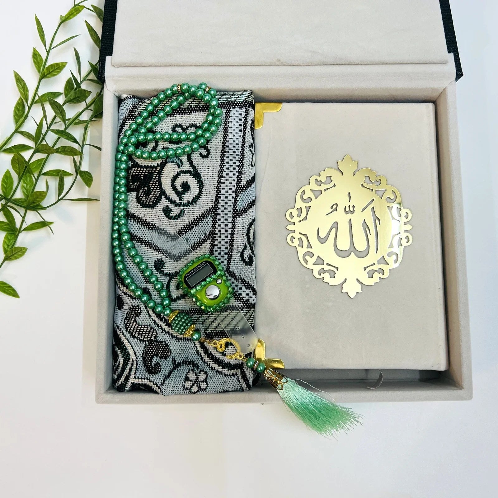 Luxury Islamic gift box in textured bottle green with velvet Quran and travel prayer rug.