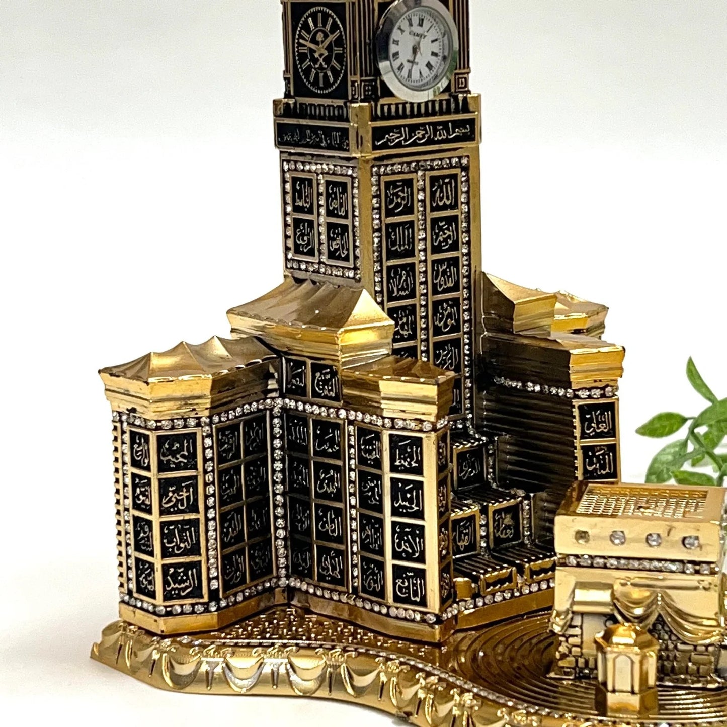 Gold Kaaba clock tower table piece with intricate Arabic calligraphy and clock.