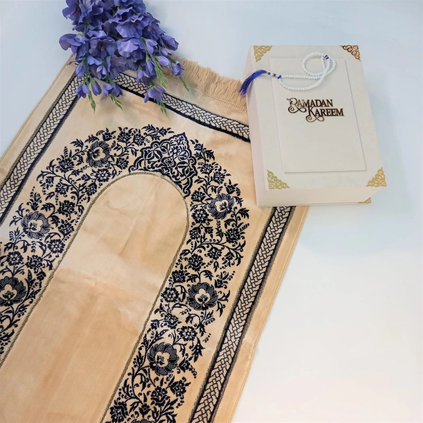 Luxury velvet Turkish prayer mat in golden yellow with blue floral pattern.