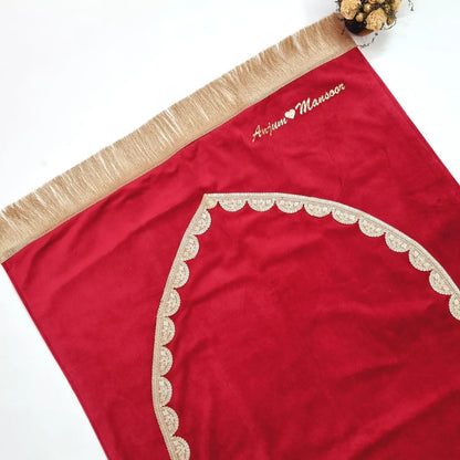 Luxurious maroon velvet prayer mat with golden lace trim and personalized name.