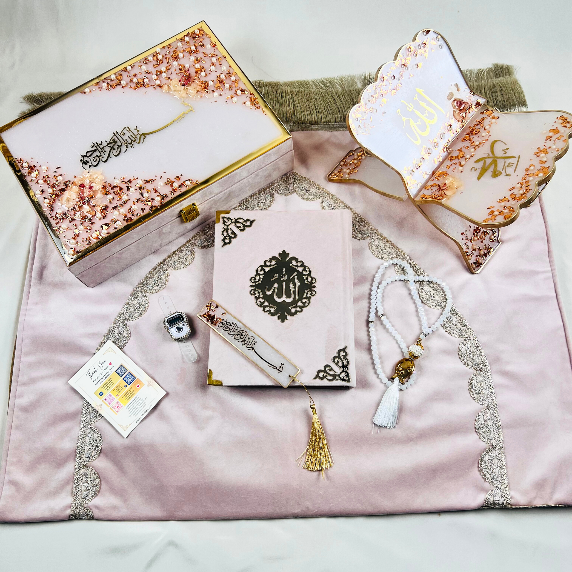 Misty Rose Barkat-e-Jariyah resin Quran hamper, luxury Islamic prayer essentials gift set including velvet Quran, handmade prayer mat, resin rehal, tasbih, bookmark, and personalized velvet box.