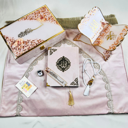 Misty Rose Barkat-e-Jariyah resin Quran hamper, luxury Islamic prayer essentials gift set including velvet Quran, handmade prayer mat, resin rehal, tasbih, bookmark, and personalized velvet box.