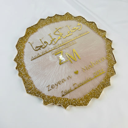Decorative gold and beige card with Arabic text on a white background