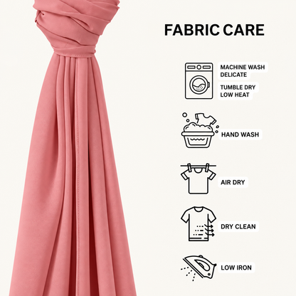 A pink fabric drape shown next to a 'FABRIC CARE' infographic with icons and text for machine wash, hand wash, air dry, dry clean, and low iron care instructions.