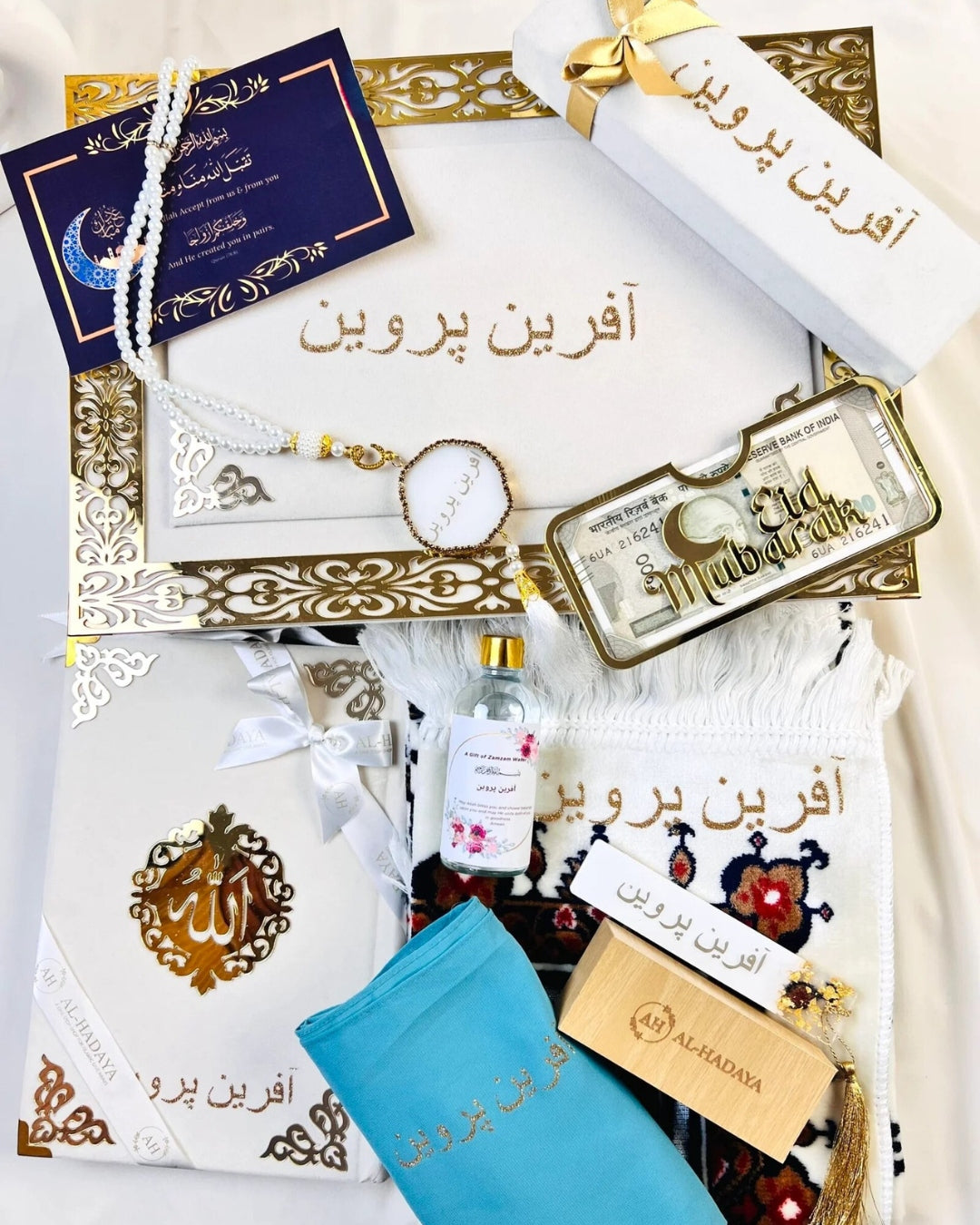 Premium velvet Quran gift set with tasbih, prayer mat, attar, and zamzam bottle by Al-Hadaya.