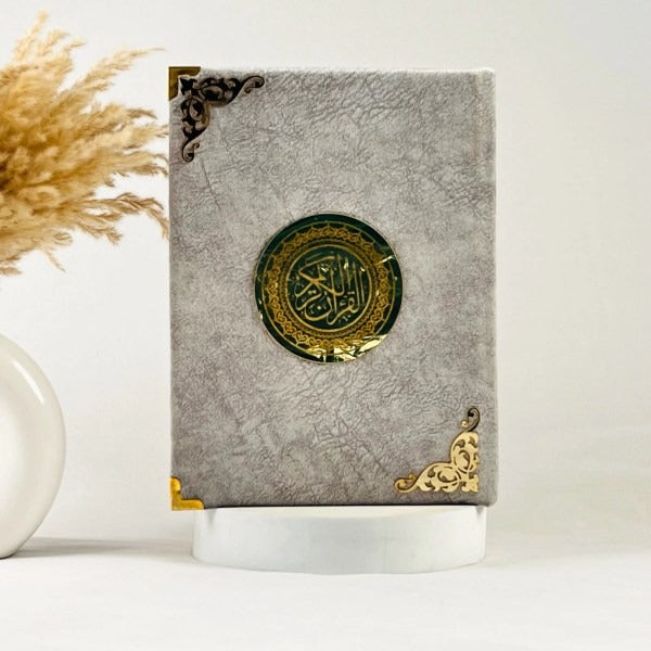 Elegant grey velvet Quran with embossed Al-Karim text on cover.