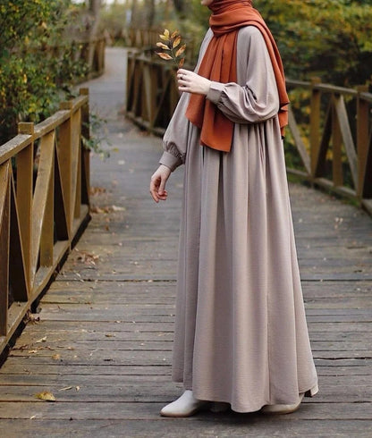 Solid Nida fabric maxi abaya with cuffed sleeves and side pockets for women.