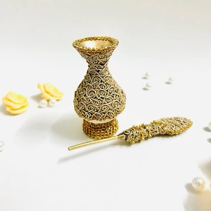 Traditional Muslim surma dani in ivory fabric and gold embellishments.