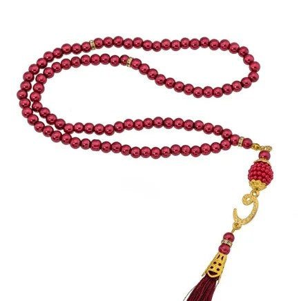 Turkish red pearl prayer beads set displayed with Islamic decor.