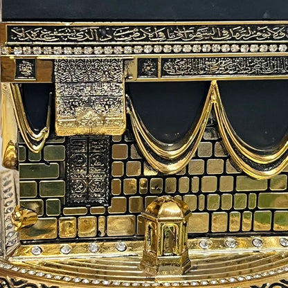 zoom in of Unique Islamic table decoration featuring Kaaba replica in gold and black.
