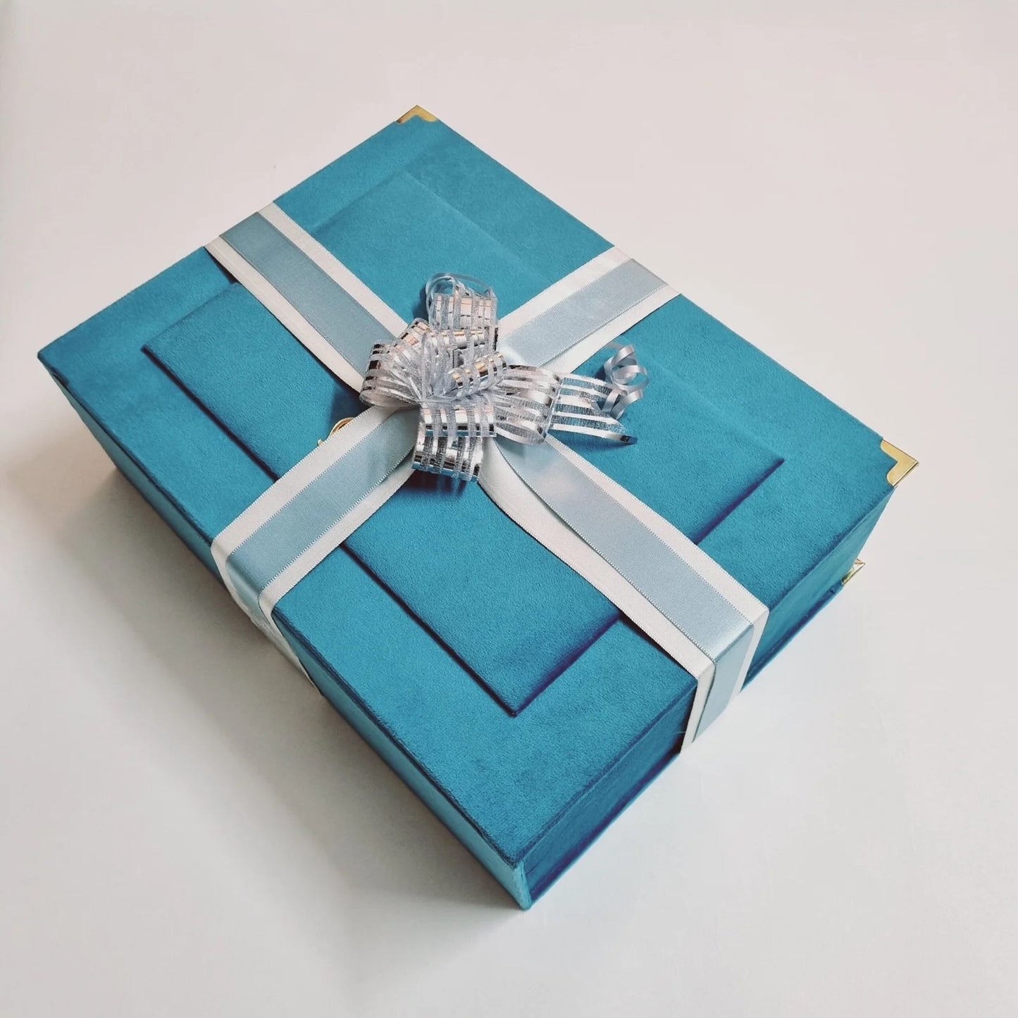 Elegant Quran and prayer mat set in a blue velvet box, ideal for Eid or Nikah gifting.