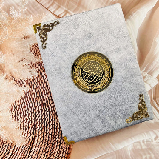 Grey velvet Holy Quran with Roman Urdu transliteration and English translation.