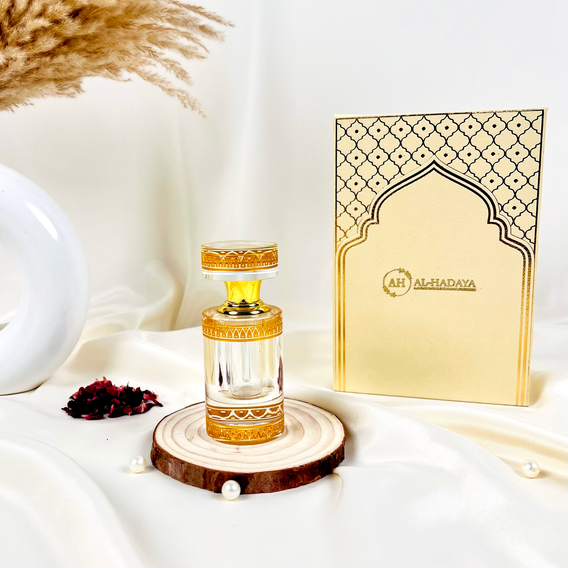 Premium Arabic attar in white crystal packaging with long-lasting oud fragrance.