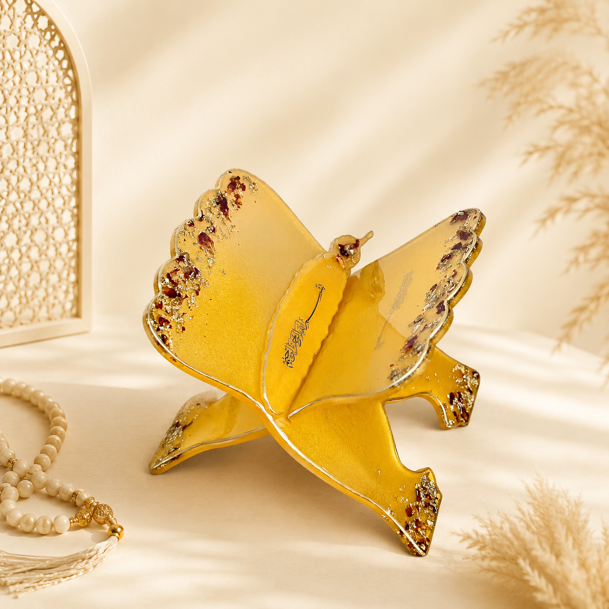 Gold bird-shaped jewelry dish on a beige background