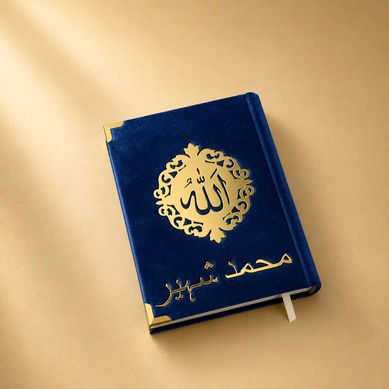 Blue quran with gold Arabic calligraphy on a beige background
