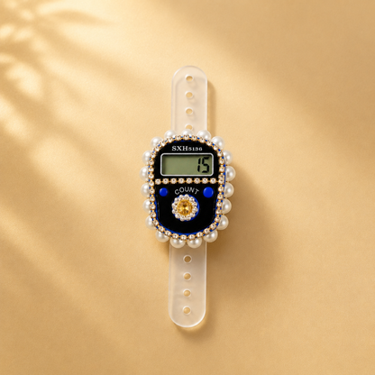 Digital watch with decorative band on a gold background