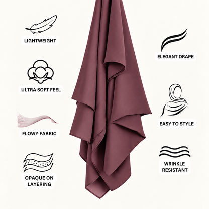 A black draped scarf or hijab is centered on a light off-white background, surrounded by feature icons and text reading Lightweight, Elegant Drape, Ultra Soft Feel, Flowy Fabric, Easy to Style, Opaque on Layering, and Wrinkle Resistant.