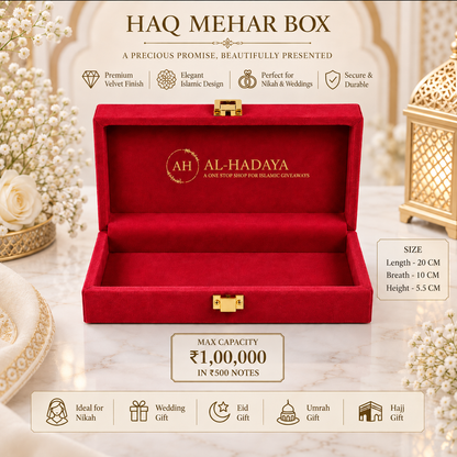 An open red velvet Haq Mehar Box by Al-Hadaya, displayed on a marble surface with decorative floral and lantern props. The box features gold hardware, a gold-foiled logo on the interior, and promotional text highlighting its size, capacity, and suitability for weddings, Eid, Umrah, and Hajj.