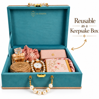 An open teal velvet keepsake box with gold-tone hardware, shown filled with jewelry and accessories. The box lid has the brand name 'AL-HADAYA' printed inside, and text on the right reads 'Reusable as a Keepsake Box' with an arrow pointing to the box.