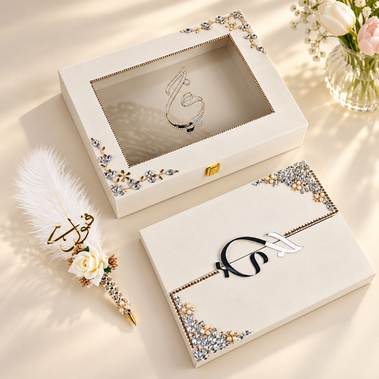 Two personalized cream-colored jewelry boxes with decorative crystal corner embellishments and a gold clasp, shown on a warm beige background with a feather pen and flowers.
